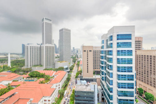 Public residential condominium building complex and downtown skylines at Bugis neighborhood in Singapore. Afternoon storm cloud sky.